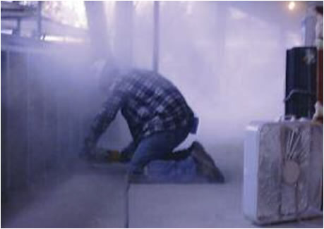 photo of worker surrounded by dust while grinding