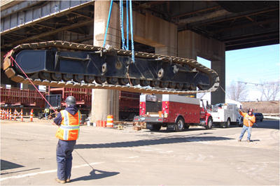 Two men guiding a lifted conveyor belt. Photo courtesy International Union of Operating Engineers and Neil W. Lippy. 