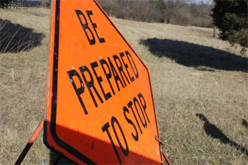 This is a photo of a standing road sign that reads: Be Prepared To Stop.