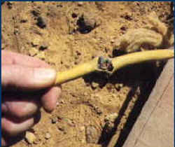 man holding broken wire near ground