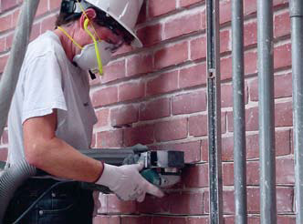 image of worker keeping grinder flat and positioned