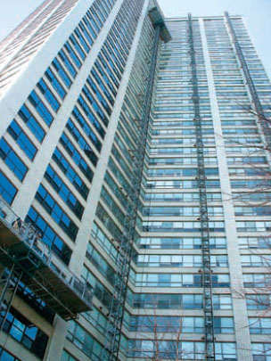 Mast climbers scale the exterior of a Chicago high-rise. Note