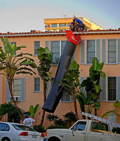 Latino construction crew close to a roof edge