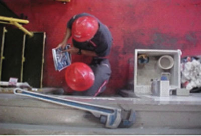 Construction workers standing where a dropped object could fall