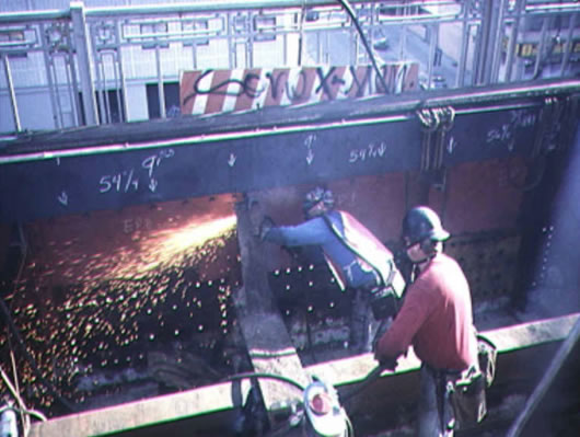 Ironworkers rehabilitating a steel bridge