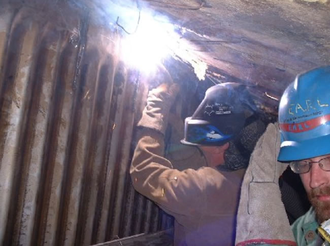 Boilermakers work on boiler tubes