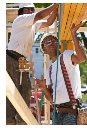 photo of workers framing a building