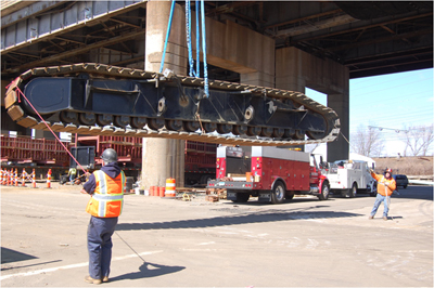 Two men guiding a lifted conveyor belt. Photo courtesy International Union of Operating Engineers and Neil W. Lippy.