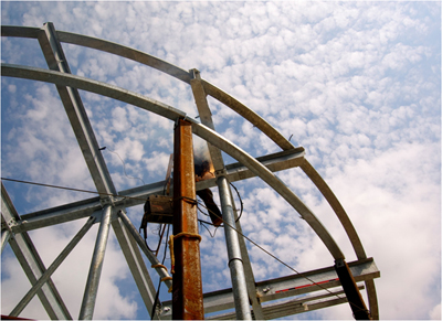 Workman sittin on beams exposed to the elements and weather. Photo courtesy CCBC and Neil W. Lippy.