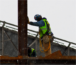 Photo of workmen working in the cold snow