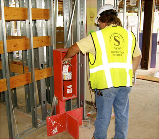 photo of a man wiht a fire extinguisher.