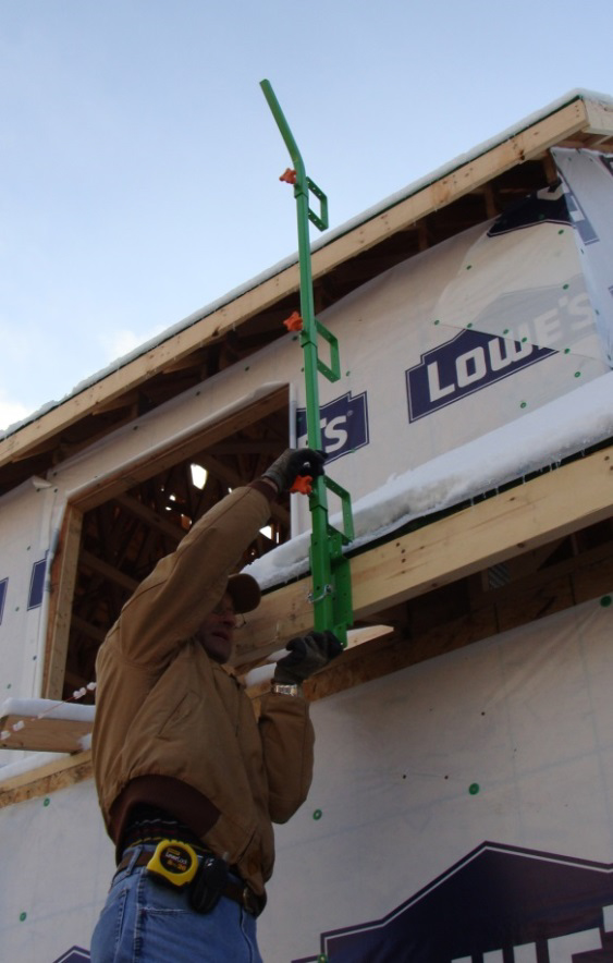 Figure 14. NIOSH researcher showing
use of offset base on fascia board. This
set-up would be installed only once and
left in place during all roofing activities.