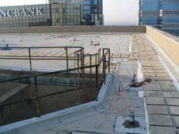 Photograph of building construction project with guard rails being installed.