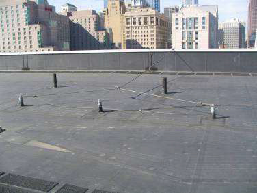 Photograph of a roof with permanent roof anchors sticking out