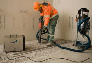 This is a picture of a worker using a hand-held transportable vacuum system