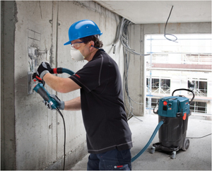 photo of a man using a tool that has a built in silica vacuum