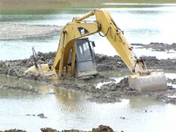 back hoe in water