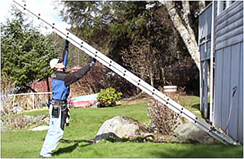 man holding the ladder up and walking forward with a hand going from rung to rung above his head