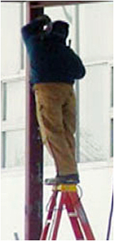 man standing on the top step of a ladder
