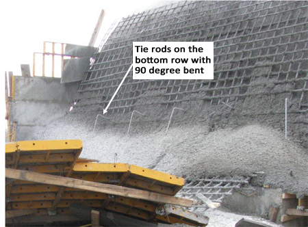 Photo 4. Tie rods that remained on the concrete bent at a nearly 90 degree angle suggesting a vertical drop in the retaining wall during collapse (photo courtesy of OSHA).