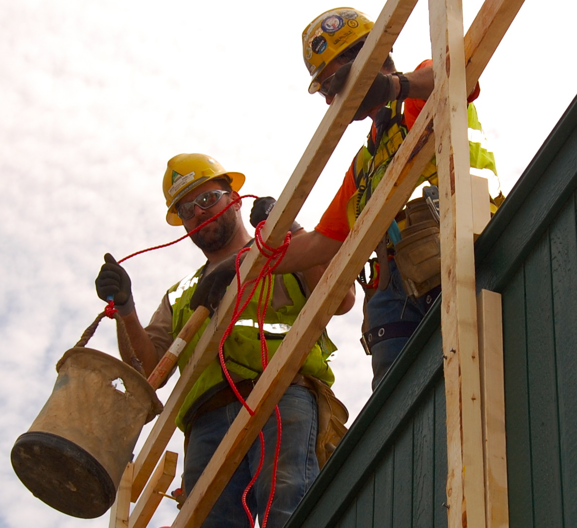 Hauling tools by bucket to prevent carrying materials up a ladder.