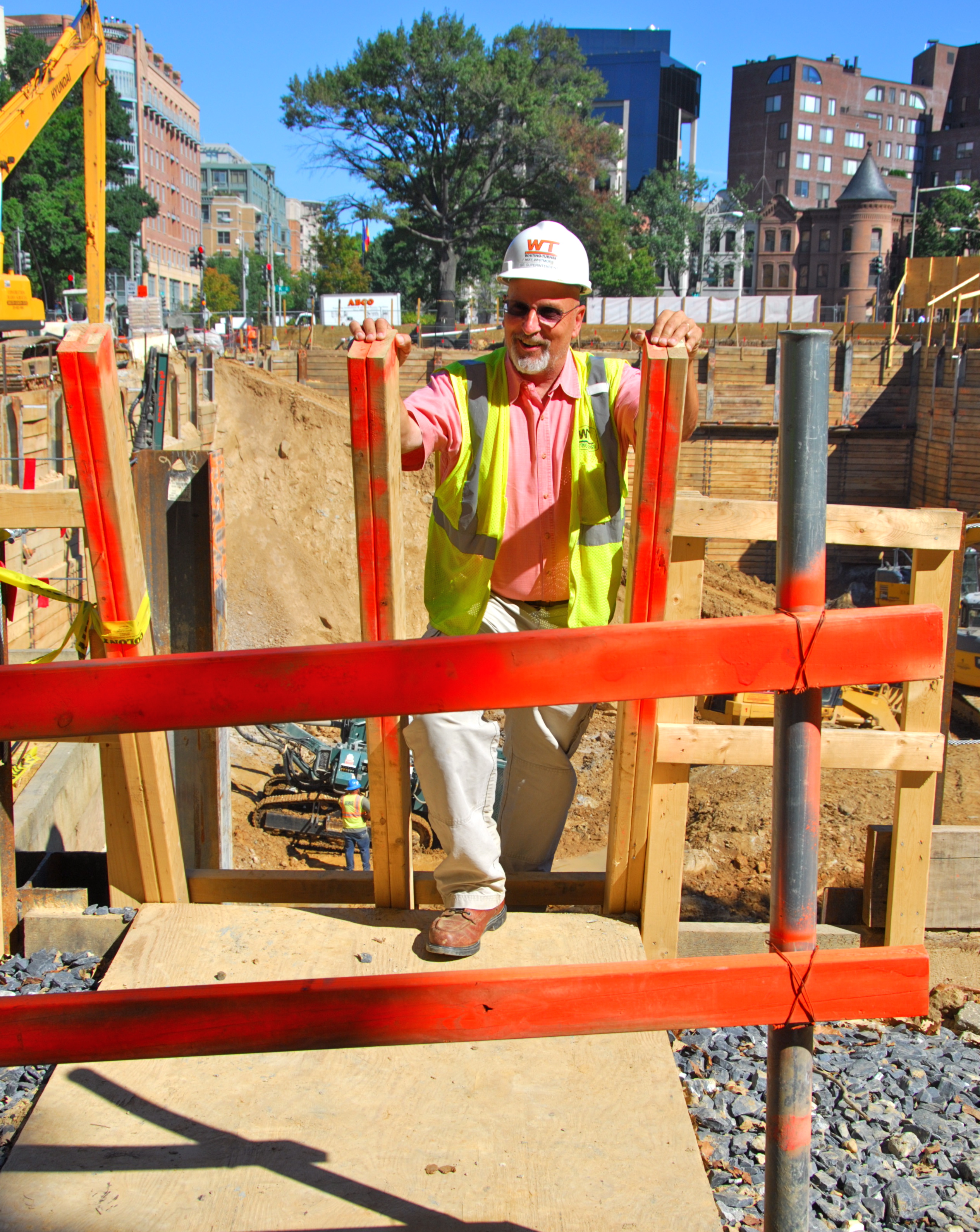 Protective barrier at top of job-built ladder