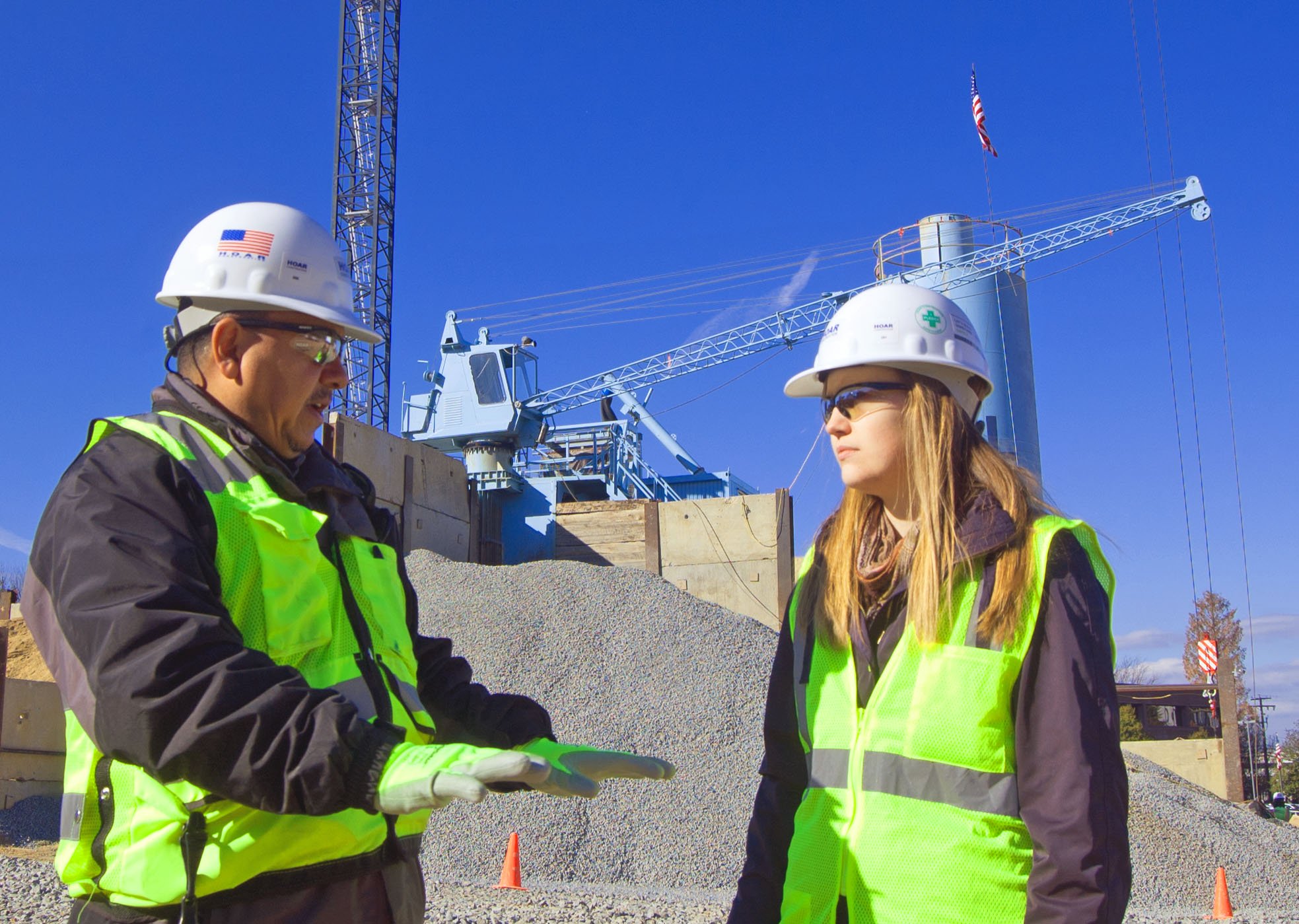 Safety officer discussing ongoing project with marketing coordinator